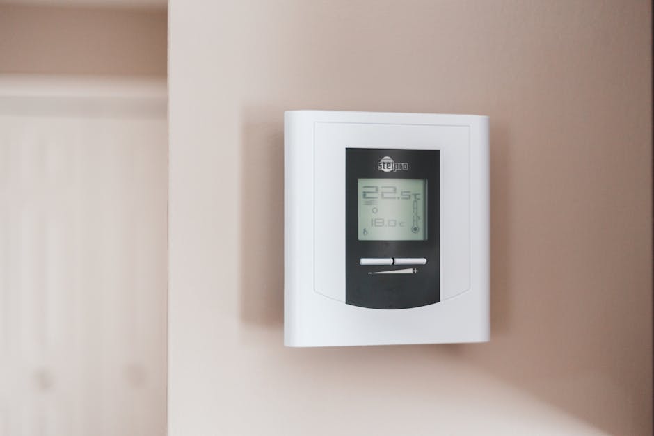 Home interior with thermostat showing climate control preparation for summer